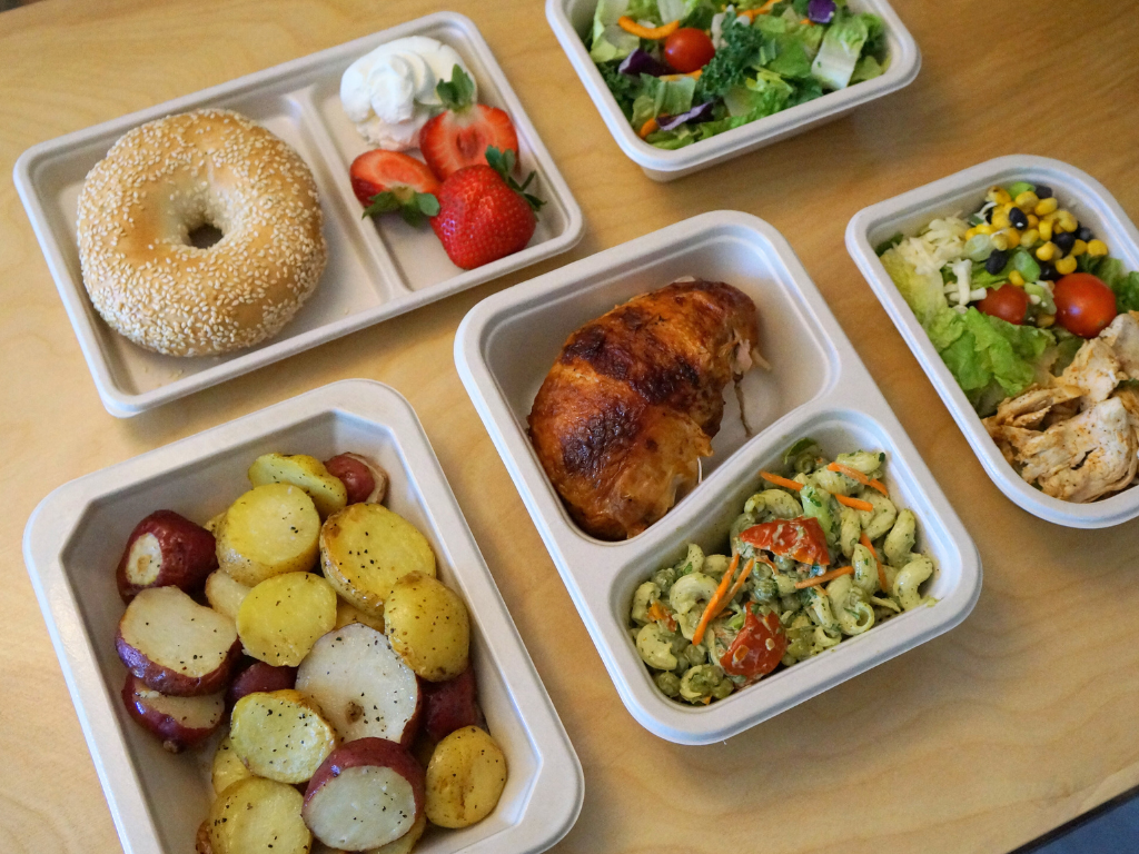 a collage of EcoFibre food trays in various sizes and food options